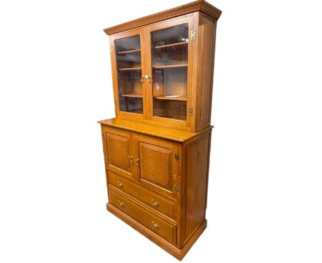 Jeremy 'Knightman' Knight oak cabinet, the glazed door top above two cupboard doors with two drawers below, 214.5cm x 117cm x
