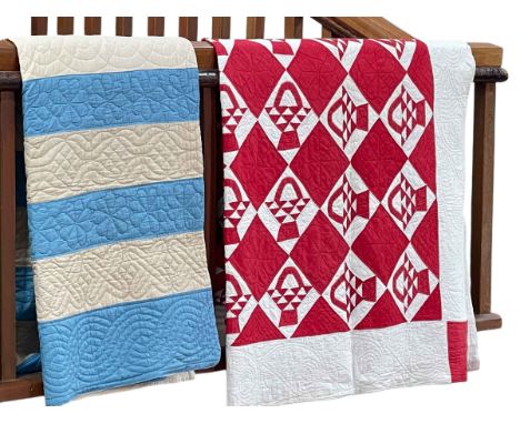 Blue and cream striped quilt and red and white diamond and flower basket decorated quilt (2).