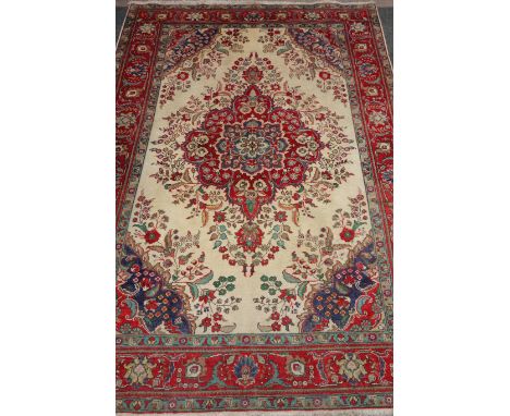 Persian Tabriz carpet, central floral medallion over cream ground spandrels red floral borders, 308cm x 203cm  Condition Repo