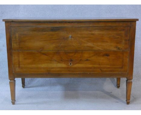 A 19th century provincial French chestnut two drawer commode with geometric lozenge inlay and stringing to the top and front 
