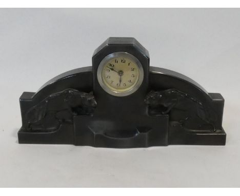 A German Art Deco spelter mantel clock, the central face flanked by crouching panthers on stepped base. H.16xW.32xL.5cm 