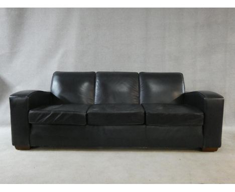 A contemporary three seater sofa in vintage style upholstered in midnight blue, from The Conran Shop. H.81xW.220xL.96cm 