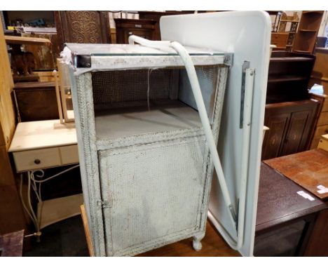 Lloyd Loom bedside cabinet with a glass top and a folding plastic and tubular steel occasional table. Not available for in-ho