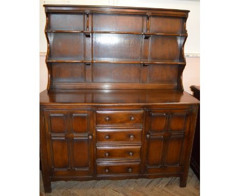 A dark stained Ercol dresser