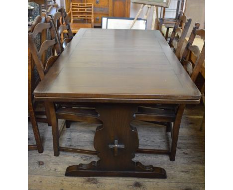 An Ercol dining table and eight chairs