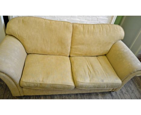 A yellow three seater sofa