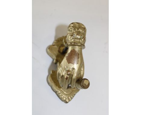 A heavy brass Victorian door knocker 