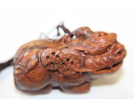 A carved wooden netsuke 7cm L 