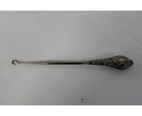 An antique hallmarked silver handled button hook 