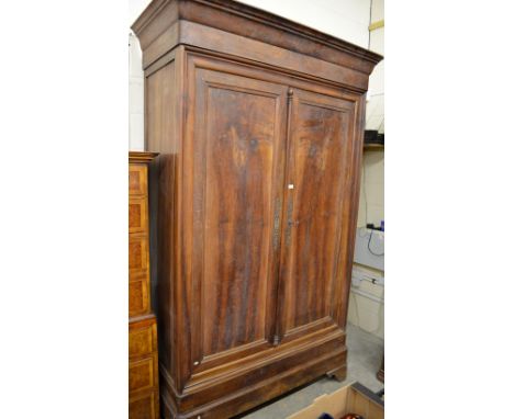 A very large 19th century French provincial walnut armoire of chateau proportion with moulded cornice above twin panelled doo