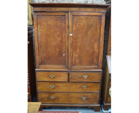 A 19th century mahogany linen press, the panel doors enclosing six slides over two short and two long graduated drawers, rais