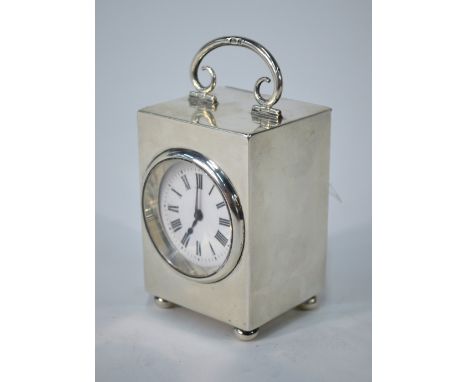 A late Victorian silver boudoir clock with hinged handle, enamel dial and bun feet, Douglas Clock Co., Birmingham 1900, 9.5 c