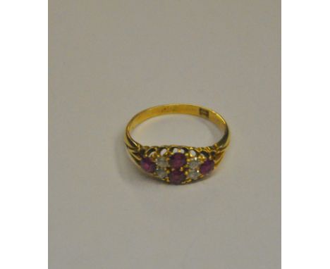 A ruby and diamond boat shaped cluster ring, set with four rubies and four diamonds in yellow gold claw setting engraved insi