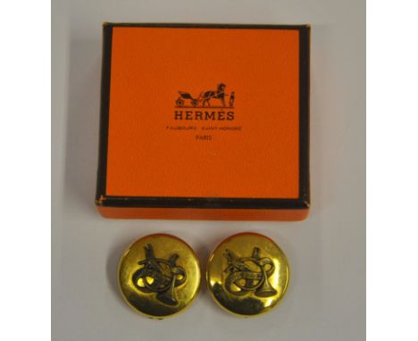 A pair of circular gilt metal clip on earrings having applied hunting horn motif in centre bears inscription Hermes Sellier P
