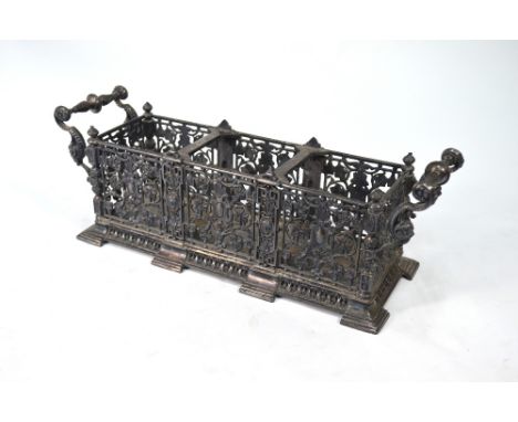 A Victorian electroplated three-bottle decanter stand, ornately-cast with openwork arabesques and scroll handles, 37 cm