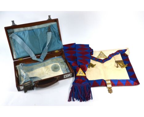 A leather case containing Masonic aprons, sash and gilt jewel