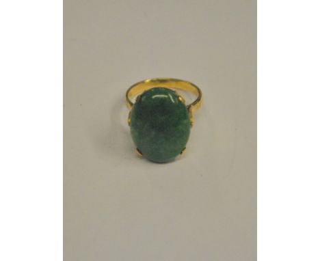 A single stone ring set oval jade cabochon, in high four claw yellow metal setting stamped 9ct, size O 1/2 Condition Report J