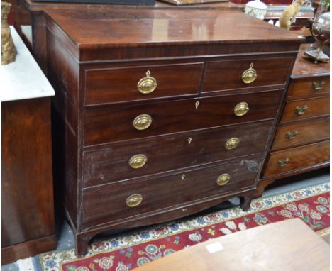 A 19th century mahogany chest of two short over three long drawers with oval brass plate and loop handles on French bracket f