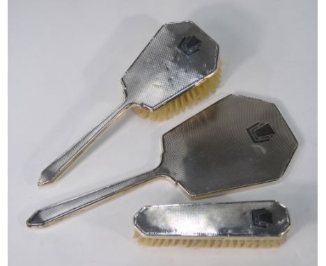 An engine-turned three-piece brush set with hand-mirror, in the Art Deco style, Daniel Manufacturing Co., Birmingham 1954