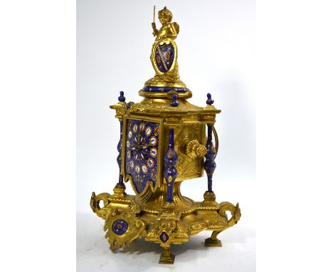 A 19th century gilt metal mantel clock in the Baroque manner, surmounted by a cherub, with Limoges-style enamel panels and mo