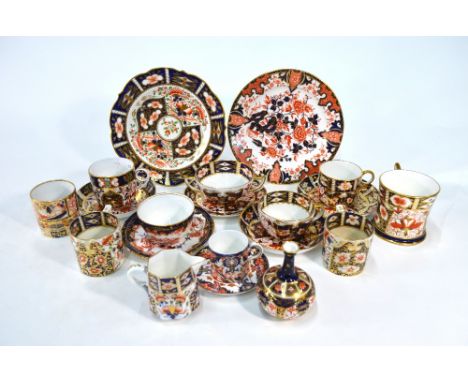 A small collection of Derby Imari decorated wares including two cups and a plate with red painted mark 1800-1825, five teacup