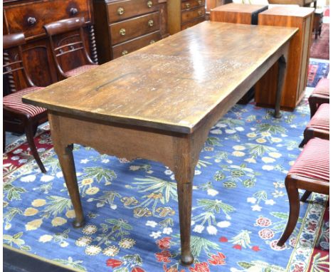 An 18th century and later joint oak refectory table, the substantial wide three plank top over a shaped frieze, raised on tur