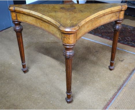 A fine quality Victorian inlaid walnut card table of inverted bow form with lobed corners, the top hinged to reveal a baize l