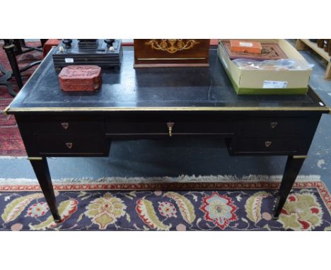 An antique Italian ormolu mounted ebonised library table, the rectangular top with tooled leather surface over an arrangement