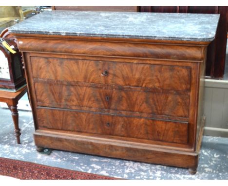 A 19th century French grey veined marble top flame mahogany commode, the cavetto drawer over three long long drawers, on turn