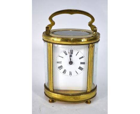 A lacquered brass carriage clock of ovoid form, the 8-day movement with white enamelled dial, 11.5 cm high