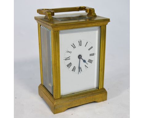 A lacquered brass 8-day carriage clock with white enamelled dial, 12 cm high