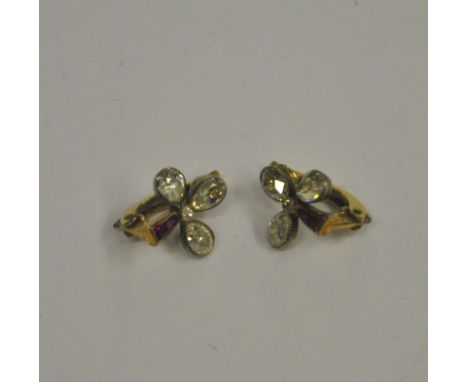 A pair of diamond and ruby trefoil ear clips, each set with three pear shaped old cut diamonds and two small baguette rubies,