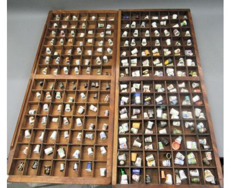 Large quantity of ceramic and other thimbles, housed in wooden display boxes 