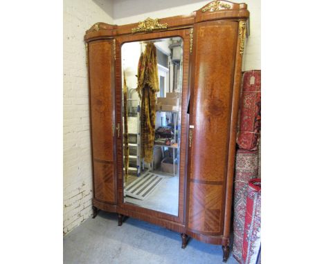 Late 19th / early 20th Century French Kingwood, amboyna and ormolu mounted wardrobe, the shaped cornice with maskhead, putto 