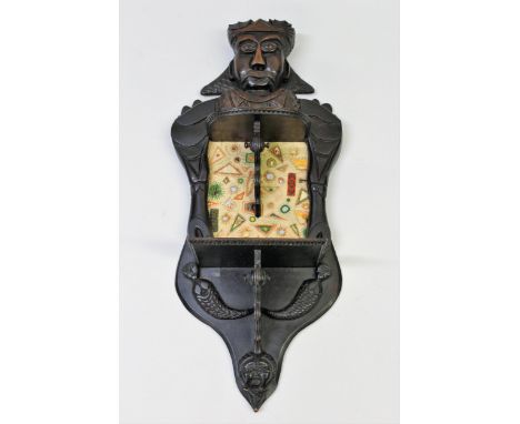 Early 20th Century figural carved hardwood wall bracket inset with an embroidered panel, inscribed to the reverse ' Made by S