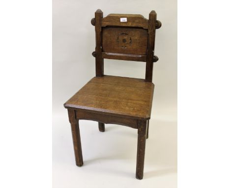 Pair of late 19th Century Gothic style hall chairs with panel backs and seats, raised on chamfered front supports 