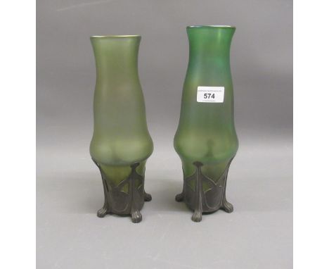 Pair of Art Nouveau iridescent green glass and pewter mounted vases on low supports, 11ins highminor chipping to rims, no clo