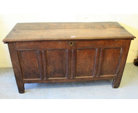 Early 18th Century oak coffer, the moulded plank top above a four panel front raised on stile feet, 52ins x 22ins x 27ins hig