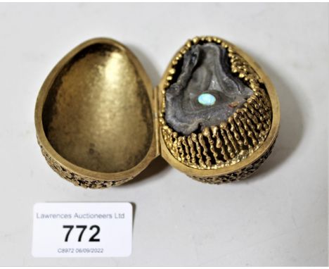 Stuart Devlin, silver gilt egg form box, the hinged lid enclosing an abstract design with central opal, 2.75ins long, 179.5gI