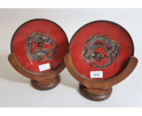 Pair of small late 19th / early 20th Century Japanese cloisonne plates decorated with dragons on a red ground, 7.25ins diamet