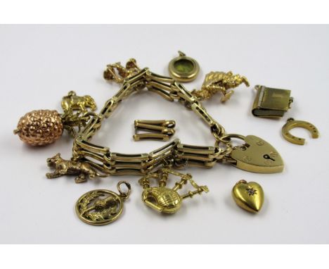 9ct Gold gate link bracelet with five attached charms, the bagpipe charm in 18ct gold, together with a single spare link and 