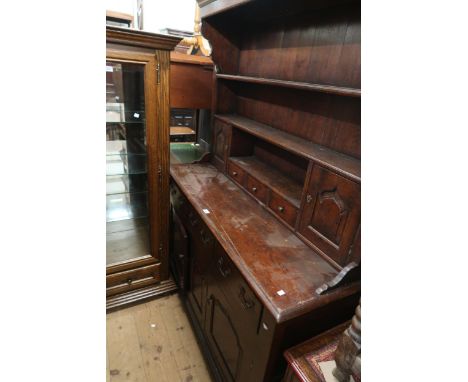 Reproduction oak dresser, the boarded shelf back with drawers and two small panel doors above three drawers and two panel doo