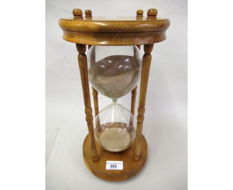 Large modern glass sand timer on a pine stand 