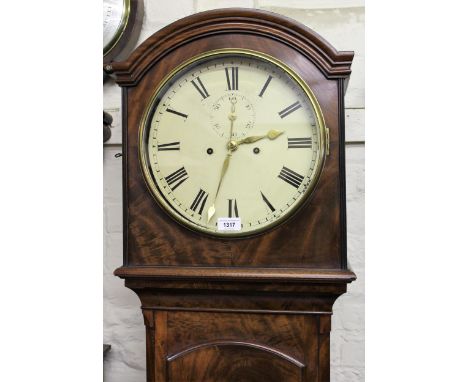 George III mahogany longcase clock, the arched hood above an arched door raised on bracket feet, the circular enamel dial wit