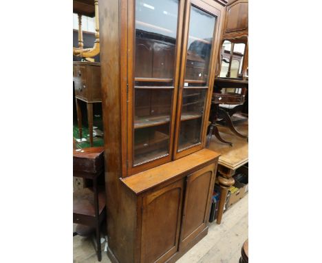 Small Victorian mahogany bookcase with two bar glazed doors enclosing shelves, the base with two arched panel doors above a p