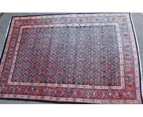 Modern central Persian carpet of Ferahan design with all-over Herati pattern on a midnight blue ground with borders, 10ft 6in