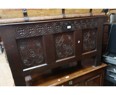 Late 17th Century oak coffer, the hinged cover above a carved three panel front raised on stile feet, 45ins x 20ins x 26ins h