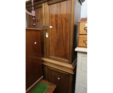 Early 20th Century mahogany side cabinet, the moulded cornice above a pair of rectangular panel doors enclosing shelves, the 