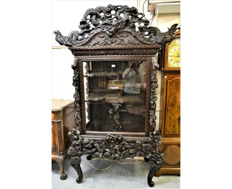 19th Century Japanese carved hardwood and lacquered display cabinet, the moulded cornice with carved and pierced surmount of 