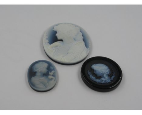 Glass cameo depicting a female portrait in profile, 2 3/8ins x 2ins approximately together with two similar smaller glass cam